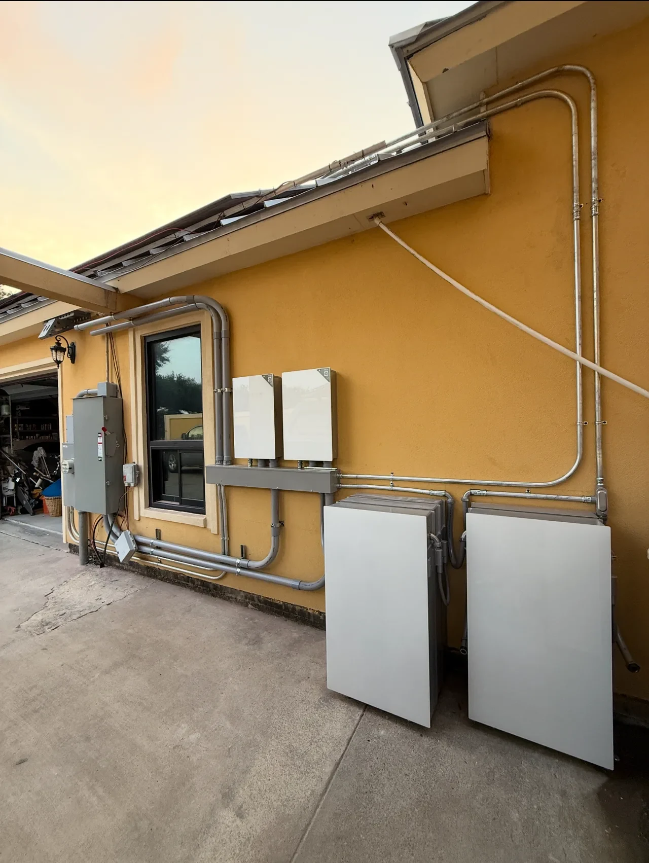 Real RGV Solar Powerwall installation on a home exterior; product logos retouched