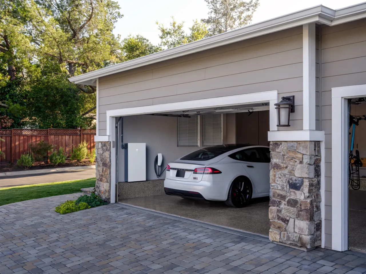 Home garage with a Powerwall 3 battery and an electric vehicle