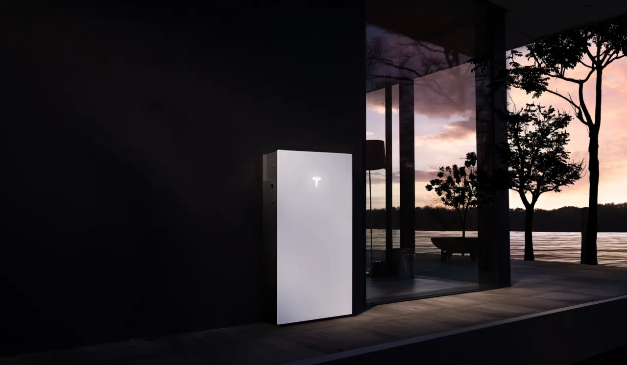 Powerwall 3 installed beside a home at sunset